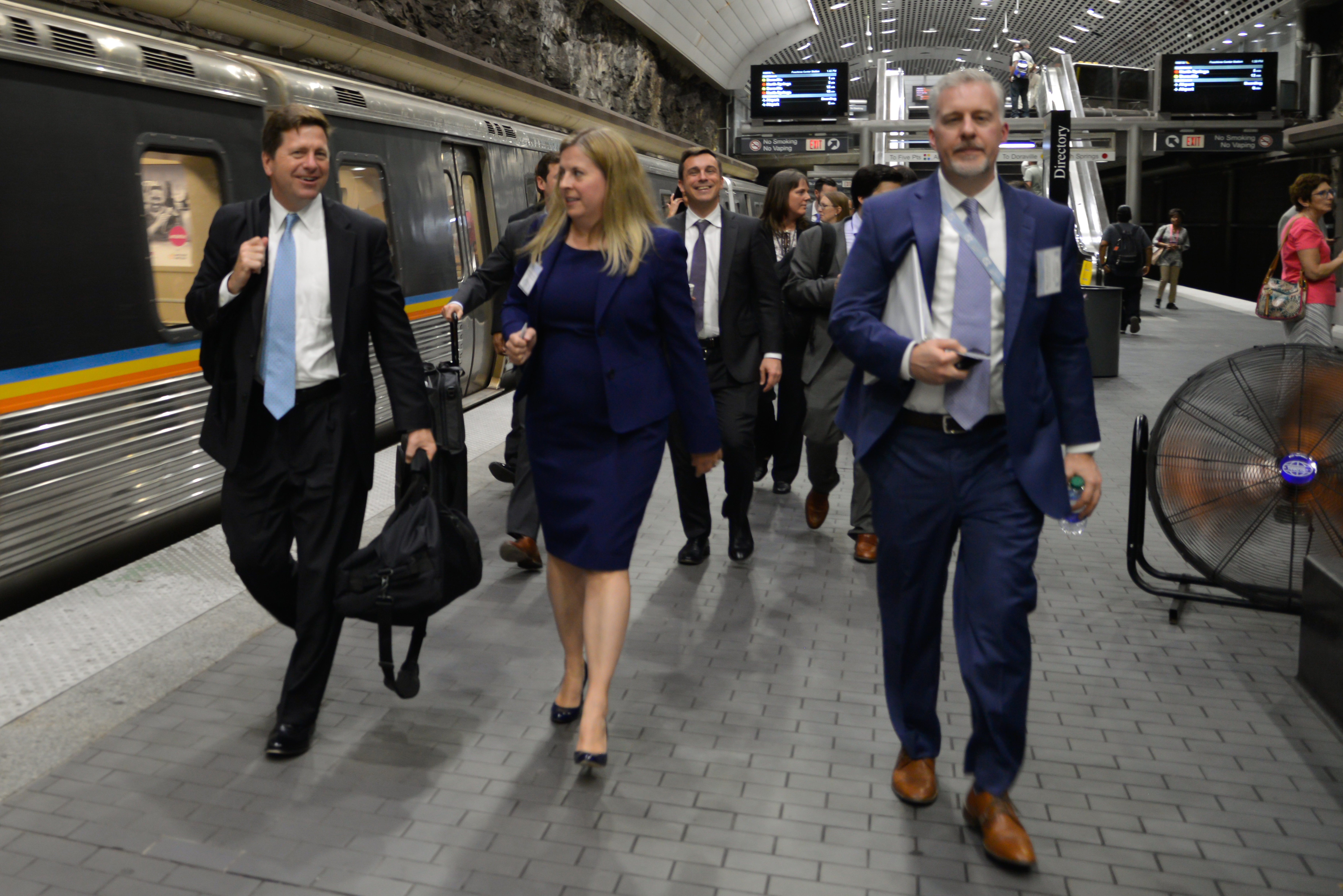 Commissioners walking through subway